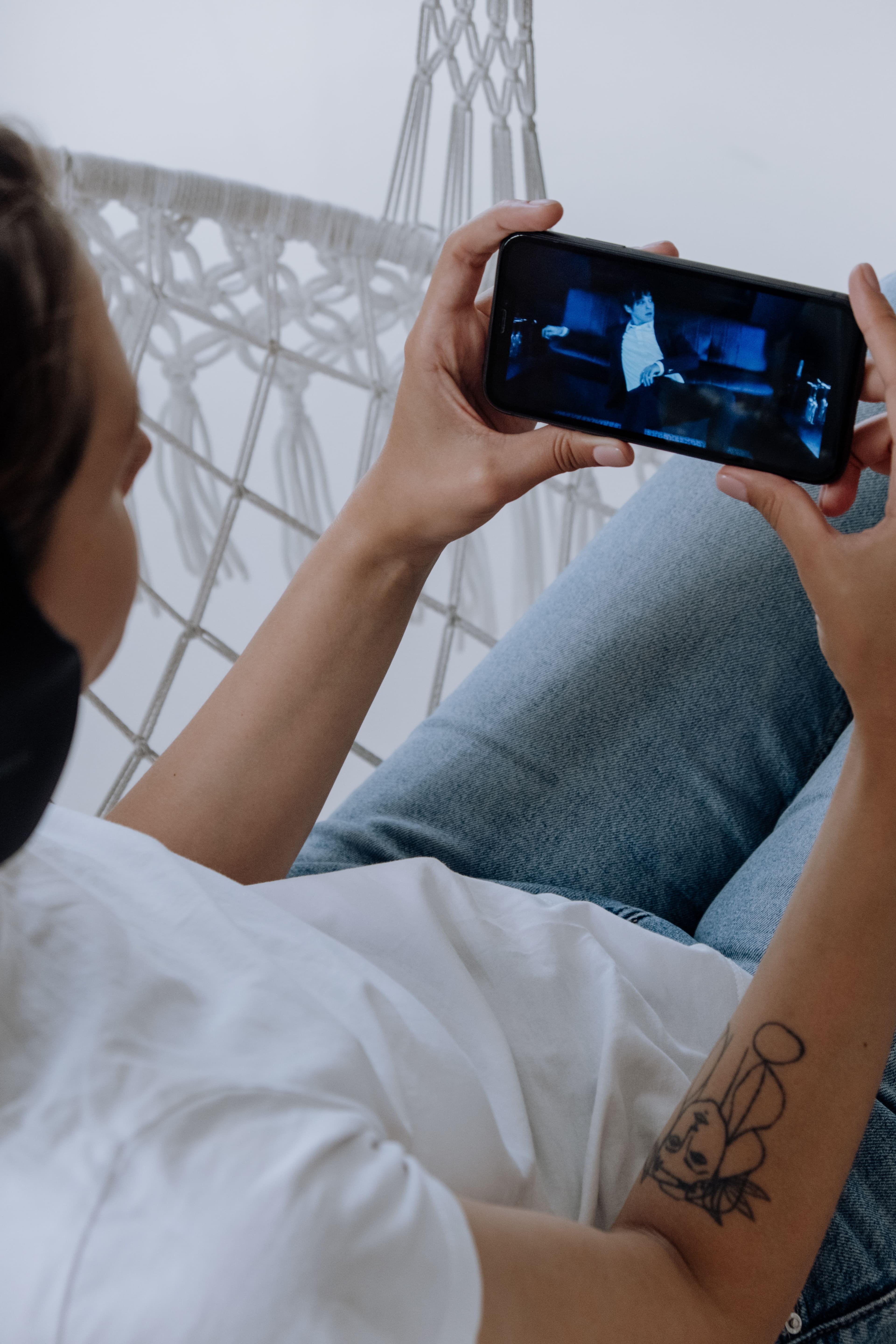 Person looking at a video on their phone